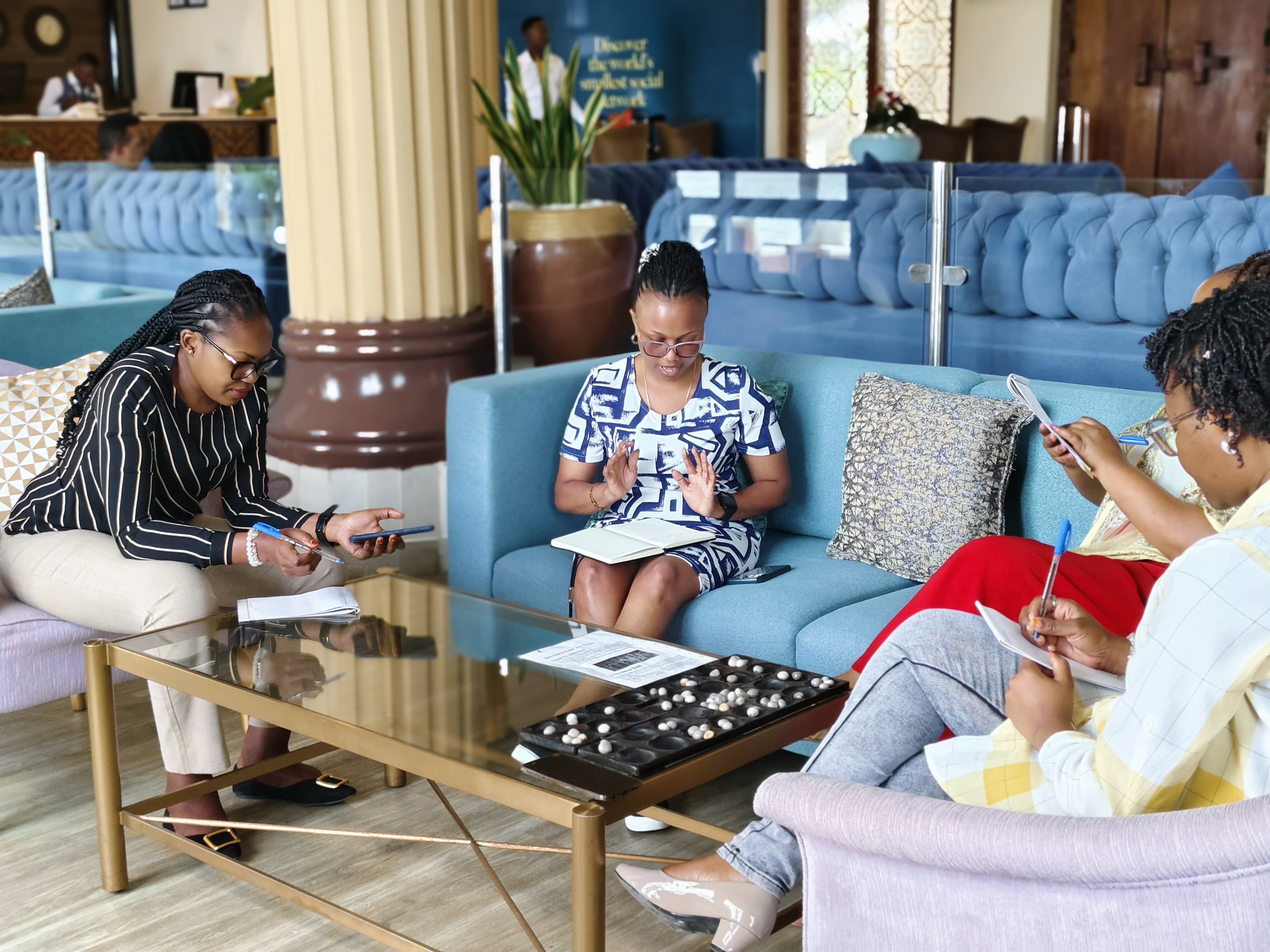 Participants working through a hands-on group exercise in a hotel lounge